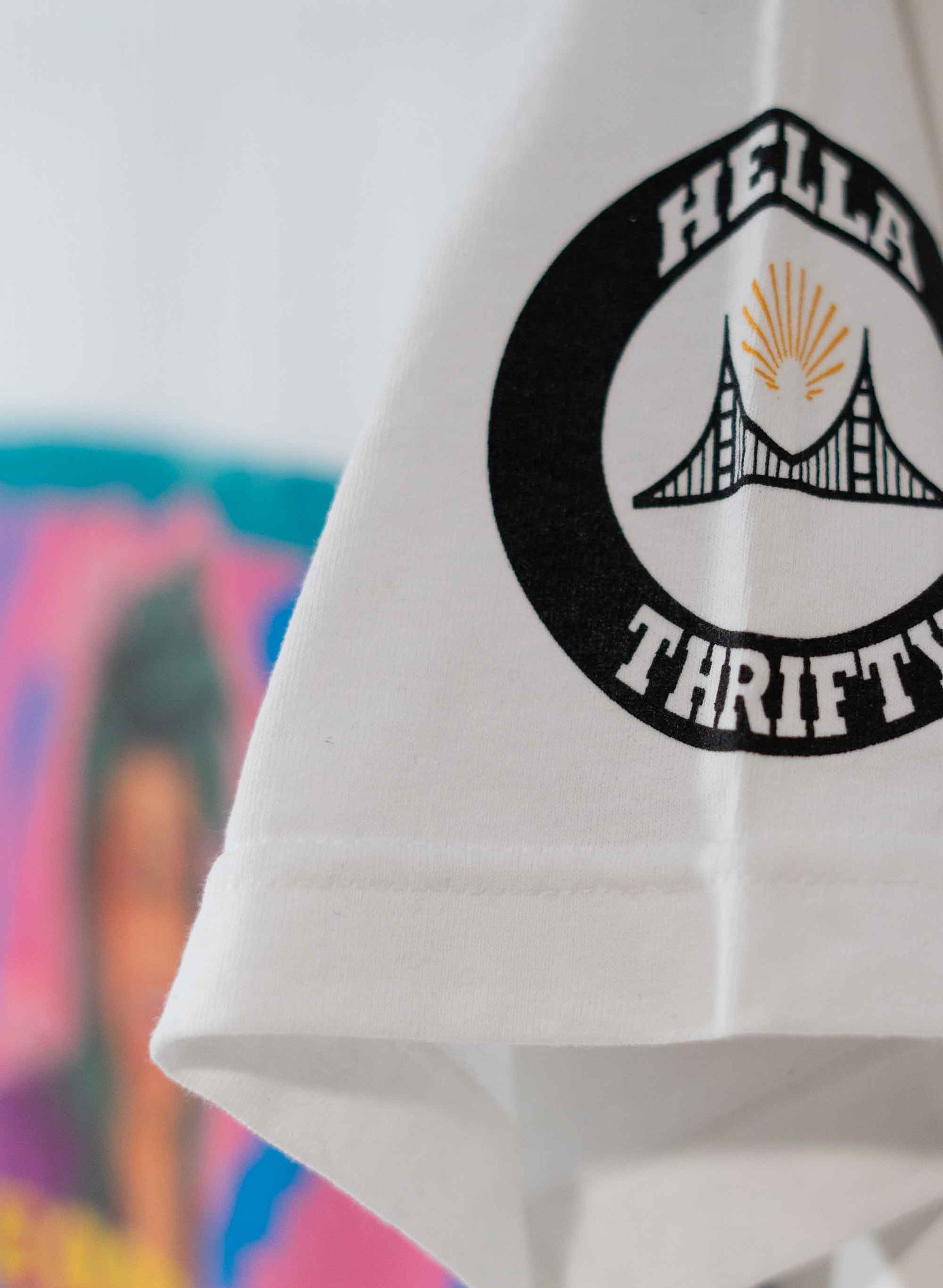 Hella Thrifty logo on the left short sleeve